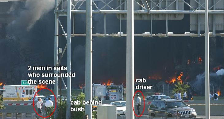 Two men in suits and cab driver Lloyde England stand near cab as Pentagon burns